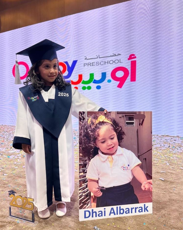 Graduate holding an award at O.baby Preschool